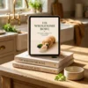 The Wholesome Bowl - Digital, Paperback, and Hardcover Formats A stack featuring the digital iPad, paperback, and hardcover editions of The Wholesome Bowl in a warm kitchen setting.